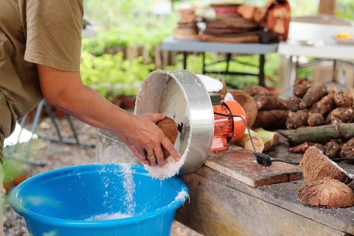 Man grating coconut over bowl